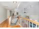 Second floor landing with banister, hardwood floors, and natural light at 11712 Black Horse Run, Raleigh, NC 27613