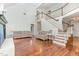 Bright, airy living room featuring hardwood floors, fireplace, and open staircase at 11712 Black Horse Run, Raleigh, NC 27613
