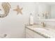 Quaint powder room featuring granite countertop, undermount sink, and decorative wall art at 11712 Black Horse Run, Raleigh, NC 27613