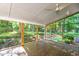 The spacious screened porch offers outdoor living and wooded views at 11712 Black Horse Run, Raleigh, NC 27613