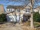 Two-story house with beige siding, stone accents, and a two-car garage at 148 Bikram Dr, Holly Springs, NC 27540