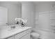 Bright bathroom featuring a white vanity, white tile flooring, and shower-tub combination at 18 Fairwinds Drive Dr, Lillington, NC 27546