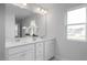 Bathroom featuring a double sink vanity, large mirror, and natural light from a window at 18 Fairwinds Drive Dr, Lillington, NC 27546