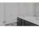 Bathroom featuring a double sink vanity with dark cabinets and white countertops and a door to the toilet area at 18 Fairwinds Drive Dr, Lillington, NC 27546
