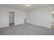 Large bedroom with soft carpet, neutral walls, and multiple doorways leading to other areas at 18 Fairwinds Drive Dr, Lillington, NC 27546
