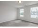 Bright bedroom with two windows that bring in lots of natural light and plush gray carpeting at 18 Fairwinds Drive Dr, Lillington, NC 27546