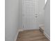 Hallway featuring a white entry door and vinyl flooring at 18 Fairwinds Drive Dr, Lillington, NC 27546