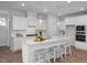 Modern kitchen featuring white cabinets, granite counters, stainless steel appliances, and a breakfast bar at 18 Fairwinds Drive Dr, Lillington, NC 27546