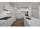 Modern kitchen featuring white cabinets, granite counters, stainless steel appliances, and a gas cooktop at 18 Fairwinds Drive Dr, Lillington, NC 27546