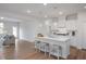 Spacious kitchen with marble counters, white cabinets and island with bar seating, open to living room at 18 Fairwinds Drive Dr, Lillington, NC 27546