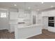 Modern kitchen with white cabinetry, granite countertops, and stainless steel appliances at 18 Fairwinds Drive Dr, Lillington, NC 27546