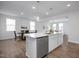 Modern kitchen with center island and breakfast bar, seamlessly flowing into a dining area at 18 Fairwinds Drive Dr, Lillington, NC 27546