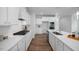 Bright kitchen features white cabinetry, granite counters, stainless appliances, and wood flooring at 18 Fairwinds Drive Dr, Lillington, NC 27546