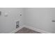 Interior view of an empty laundry room with tile flooring and washer/dryer hookups at 18 Fairwinds Drive Dr, Lillington, NC 27546