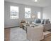 Bright living room with neutral furniture, wood flooring, and ample natural light from large windows at 18 Fairwinds Drive Dr, Lillington, NC 27546