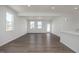 Spacious living room with modern lighting, vinyl floors and large windows at 18 Fairwinds Drive Dr, Lillington, NC 27546