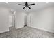 Bright bedroom with ceiling fan, neutral walls, gray carpeting and access to bathroom at 195 Daniel Ridge Ln, Roxboro, NC 27574