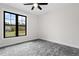 Bedroom with gray carpet and a large window with wooded view at 195 Daniel Ridge Ln, Roxboro, NC 27574