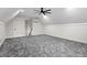 Large bonus room with grey carpet, ceiling fan, and HVAC unit at 195 Daniel Ridge Ln, Roxboro, NC 27574