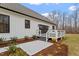 Spacious deck with gray railings and steps leading to patio at 195 Daniel Ridge Ln, Roxboro, NC 27574