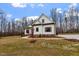 White farmhouse with gray roof, brick base, and landscaping at 195 Daniel Ridge Ln, Roxboro, NC 27574