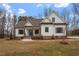 Two-story farmhouse with white siding, brown accents, and a teal door at 195 Daniel Ridge Ln, Roxboro, NC 27574
