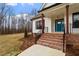 Brick steps leading to a teal front door with modern railing at 195 Daniel Ridge Ln, Roxboro, NC 27574