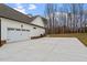 Two-car garage with white doors and a large concrete driveway at 195 Daniel Ridge Ln, Roxboro, NC 27574