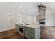 Open concept kitchen with island and stainless steel appliances, adjacent to fireplace at 195 Daniel Ridge Ln, Roxboro, NC 27574