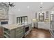 Open concept kitchen with island, stainless steel appliances, and views to backyard at 195 Daniel Ridge Ln, Roxboro, NC 27574