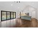 Open concept kitchen with island, stainless steel appliances, and sliding glass doors leading to backyard at 195 Daniel Ridge Ln, Roxboro, NC 27574
