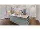 Modern kitchen with white cabinets, granite countertops, and green island at 195 Daniel Ridge Ln, Roxboro, NC 27574