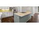 Modern kitchen with white cabinets, granite countertops, and green island at 195 Daniel Ridge Ln, Roxboro, NC 27574