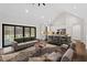 Virtually staged living room features a gray sofa and a coffee table, open to the kitchen at 195 Daniel Ridge Ln, Roxboro, NC 27574