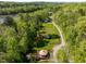 Aerial view of a property with a unique yurt, a garden, and wooded surroundings at 196 Paces Mill Trl, Pittsboro, NC 27312