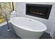 Modern soaker tub in a bathroom with a fireplace at 196 Paces Mill Trl, Pittsboro, NC 27312