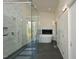Bright bathroom features a glass shower, soaking tub with fireplace, and modern tile at 196 Paces Mill Trl, Pittsboro, NC 27312