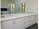 Modern bathroom featuring double sinks, white marble counters, and large mirror at 196 Paces Mill Trl, Pittsboro, NC 27312