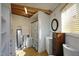 Bright bathroom features wooden beam accents, storage cabinet and shower at 196 Paces Mill Trl, Pittsboro, NC 27312