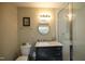 Bathroom with a walk-in shower, vanity, and oval mirror above the sink at 196 Paces Mill Trl, Pittsboro, NC 27312