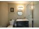 Well-lit bathroom with a modern vanity, mirror, and a glass-enclosed shower for a spa-like experience at 196 Paces Mill Trl, Pittsboro, NC 27312