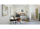 Bright bedroom featuring a modern desk, minimalist decor, and an ensuite bathroom for added convenience at 196 Paces Mill Trl, Pittsboro, NC 27312
