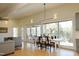 Sunlit dining room featuring modern light fixture and floor-to-ceiling windows with a deck view at 196 Paces Mill Trl, Pittsboro, NC 27312