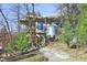 Modern exterior of home with tank, small deck, wooden staircase and gravel path at 196 Paces Mill Trl, Pittsboro, NC 27312
