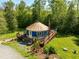 Aerial view of a unique yurt-style home featuring a spacious deck and lush greenery at 196 Paces Mill Trl, Pittsboro, NC 27312