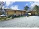 Modern single-story home with minimalist design, neutral colors, well-kept lawn, and gravel driveway at 196 Paces Mill Trl, Pittsboro, NC 27312