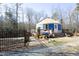 Charming yurt with fenced walkway, wooden deck, and lush surroundings for a unique living experience at 196 Paces Mill Trl, Pittsboro, NC 27312