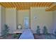 Modern front door with transom windows, transom over door, covered landing and xeriscaping at 196 Paces Mill Trl, Pittsboro, NC 27312