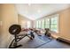 Dedicated home gym with plenty of natural light, equipped with weights, exercise equipment for fitness enthusiasts at 196 Paces Mill Trl, Pittsboro, NC 27312