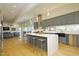 Bright, contemporary kitchen featuring a large island with seating and stainless steel appliances at 196 Paces Mill Trl, Pittsboro, NC 27312